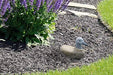 6 inch Boulder Duck stone statue displayed in garden mulch bed