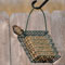 C&S EZ Fill cage bird feeder hanging outdoors against a stone wall background