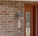 Woodstock Birdfeeder Chime hanging outdoors with birds feeding