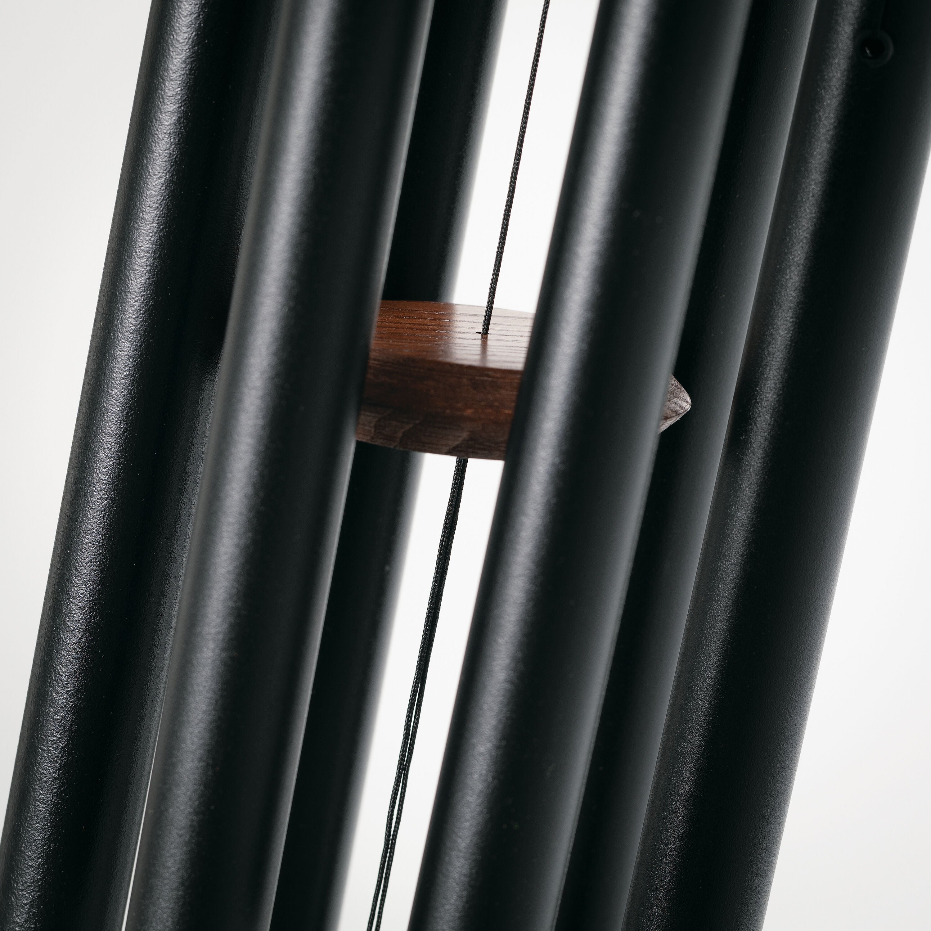 Chimes of Pluto Black/Teak chime hanging outdoors