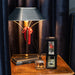 Comfort & Joy Reed Diffuser on a wooden side table with lamp and blue curtains