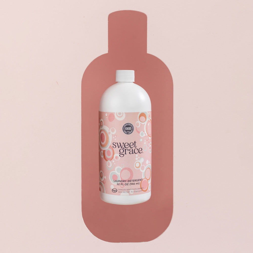 Sweet Grace 32oz Laundry Detergent bottle against pink background