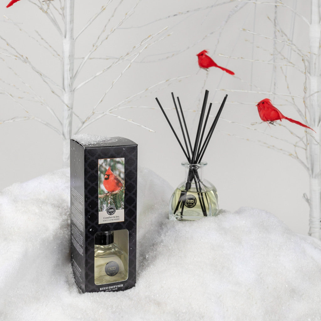 Comfort & Joy Reed Diffuser on artificial snow with cardinal bird accents