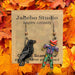 Jabebo Crow and Scarecrow dangle earrings on branded card, black crow and colorful scarecrow design